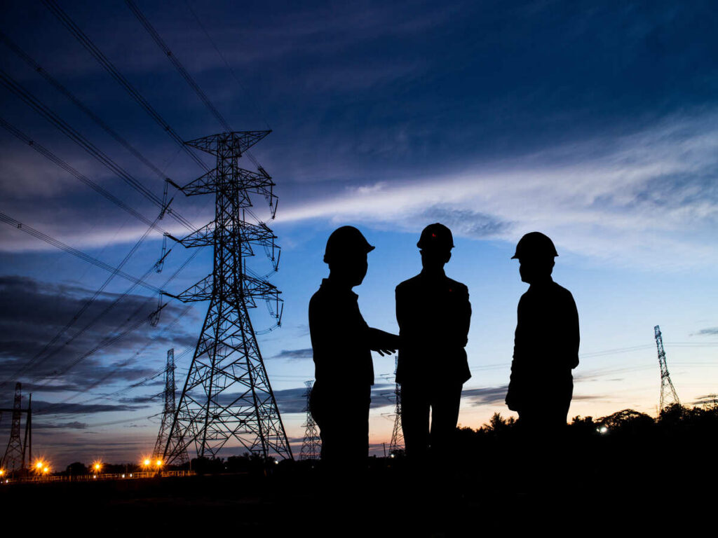 Three men in silhouette discussing